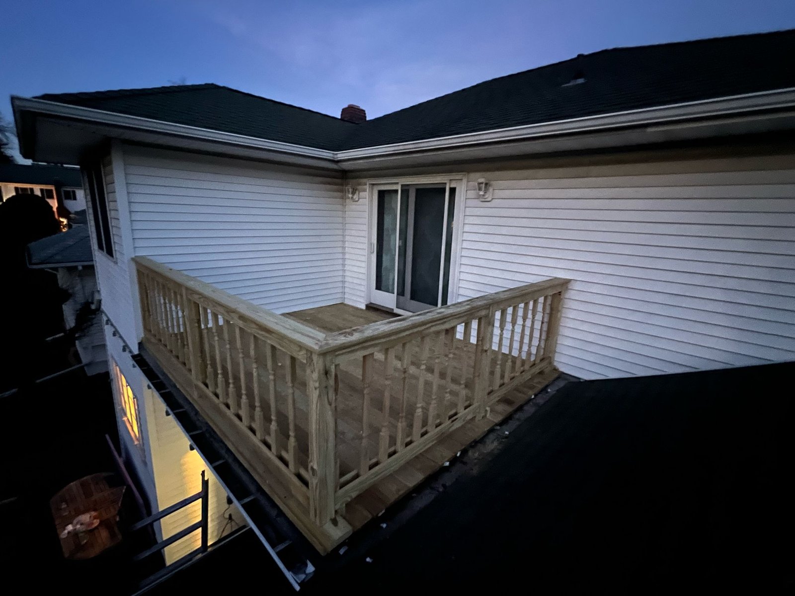 Finished rooftop deck at dusk, left view