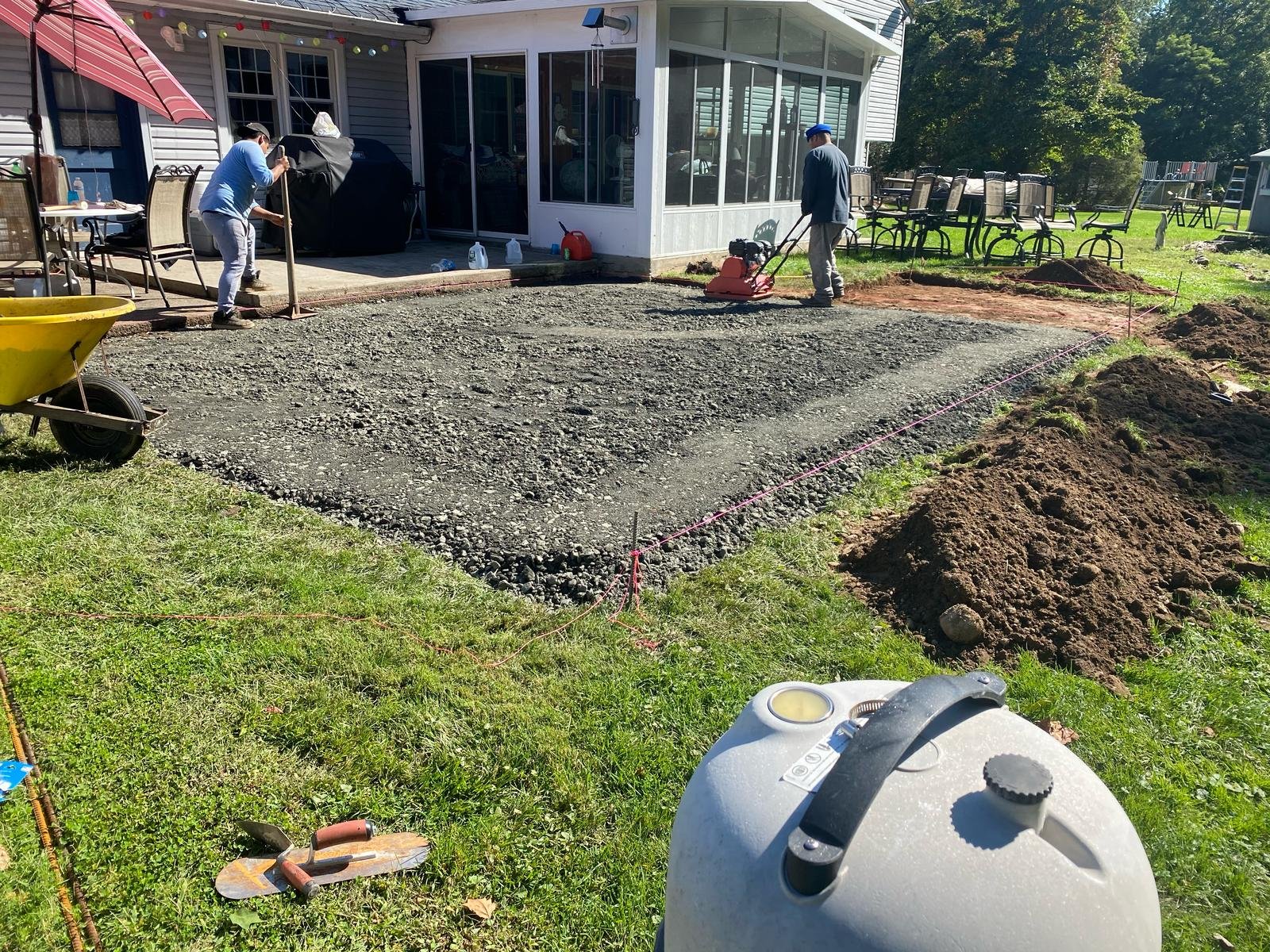 Vibratory plate compacting six-inch stone base