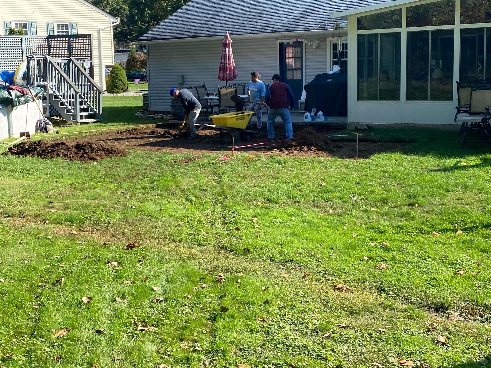 Crew excavating and shaping patio footprint