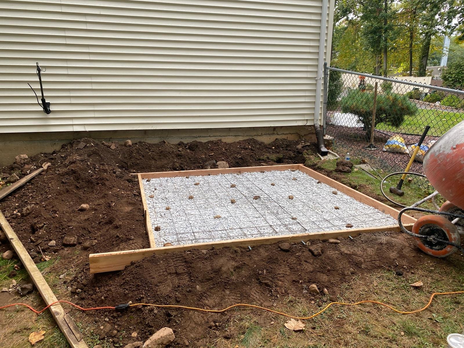 Formed concrete pad with welded wire mesh reinforcement