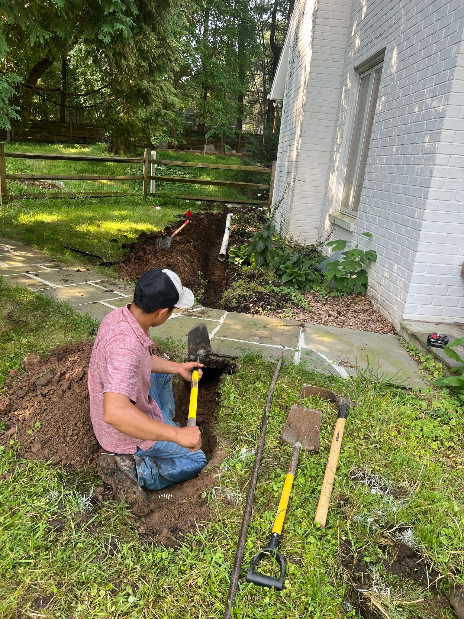 Crew digging trench for French drain line